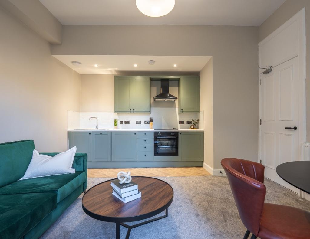 A modern, clean kitchen area featuring sleek ca...