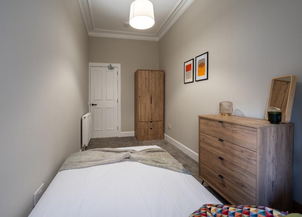 Neat and well-maintained small bedroom featurin...