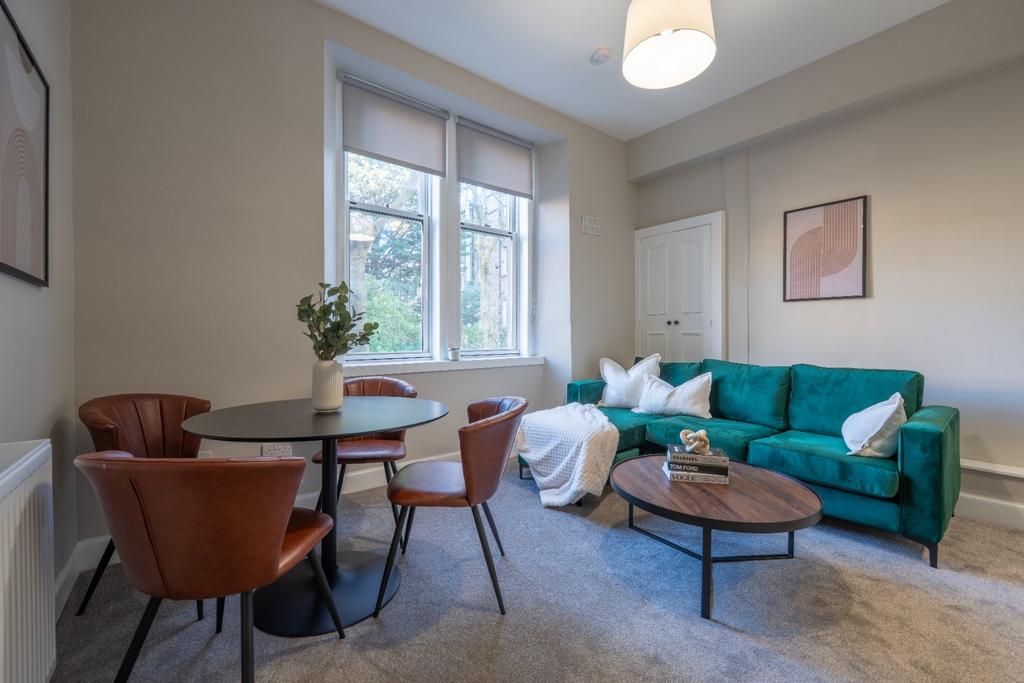 Bright and contemporary living room featuring a...