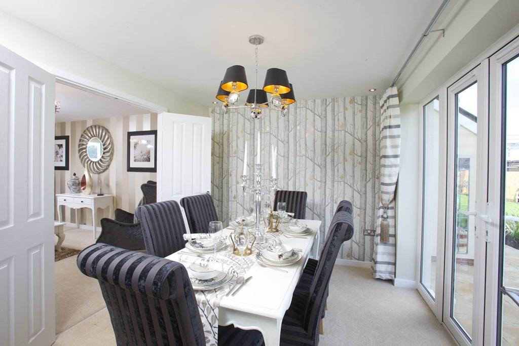 The adjoining dining area features double doors...