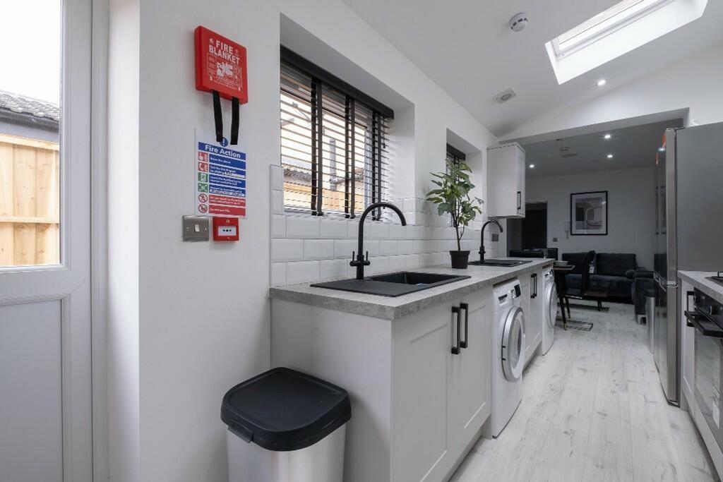 Modern kitchen featuring sleek countertops, amp...