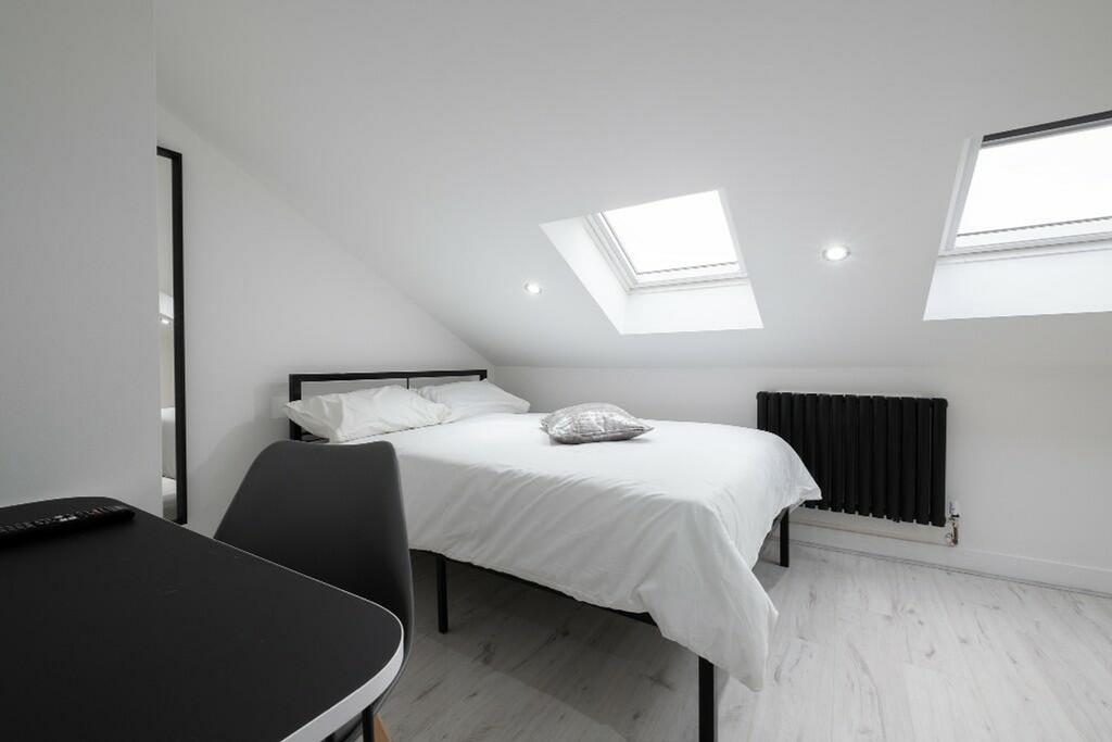 This inviting double bedroom features a comfort...