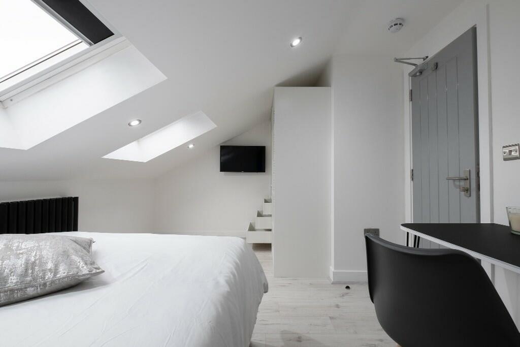 This stylish double bedroom features ample natu...
