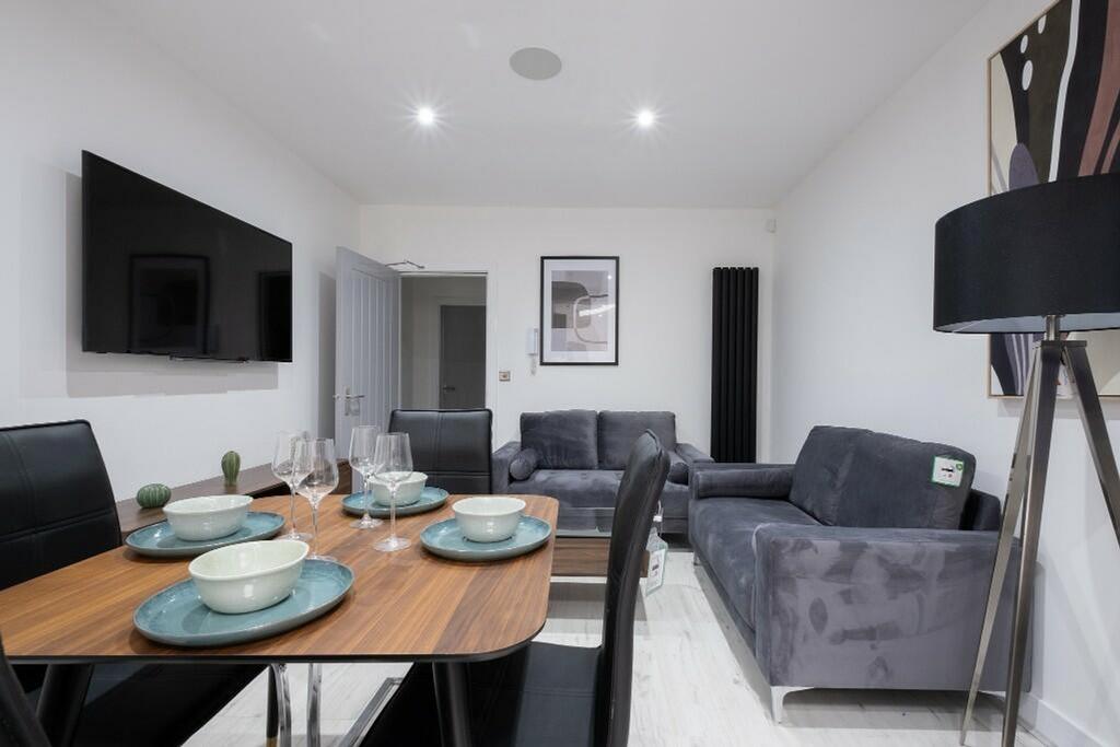 Contemporary living room featuring a stylish di...