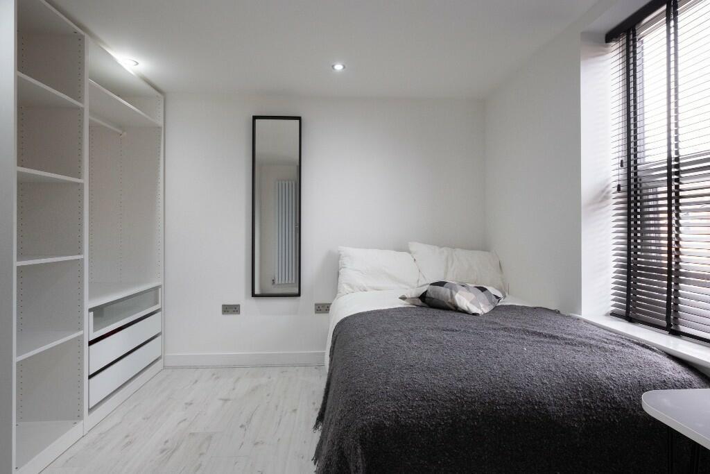 Modern and spacious master bedroom featuring a ...