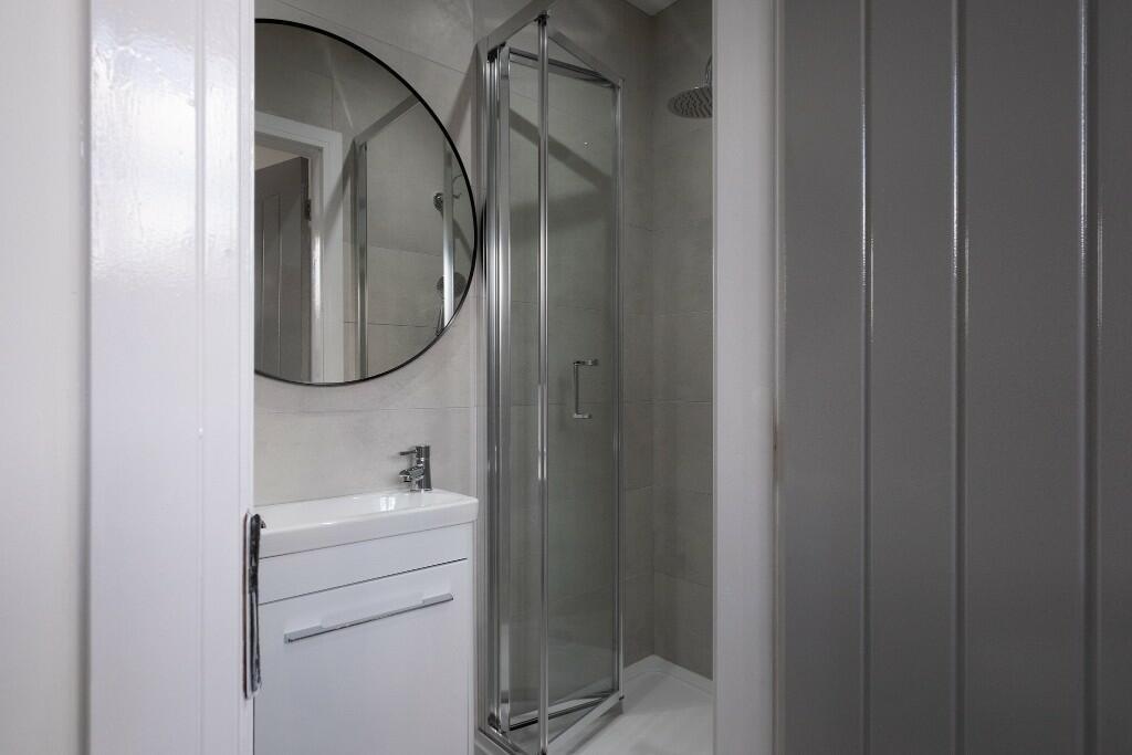 A modern and clean bathroom with a spacious sho...