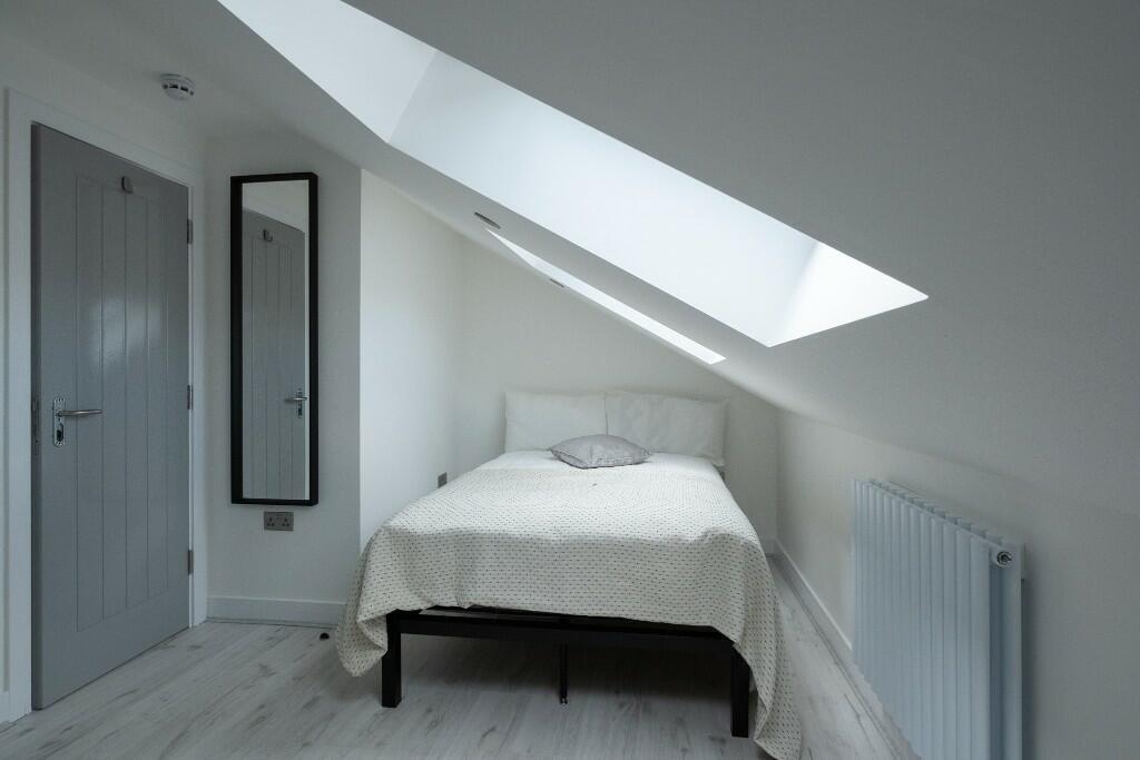 A bright and airy bedroom with a large skylight...