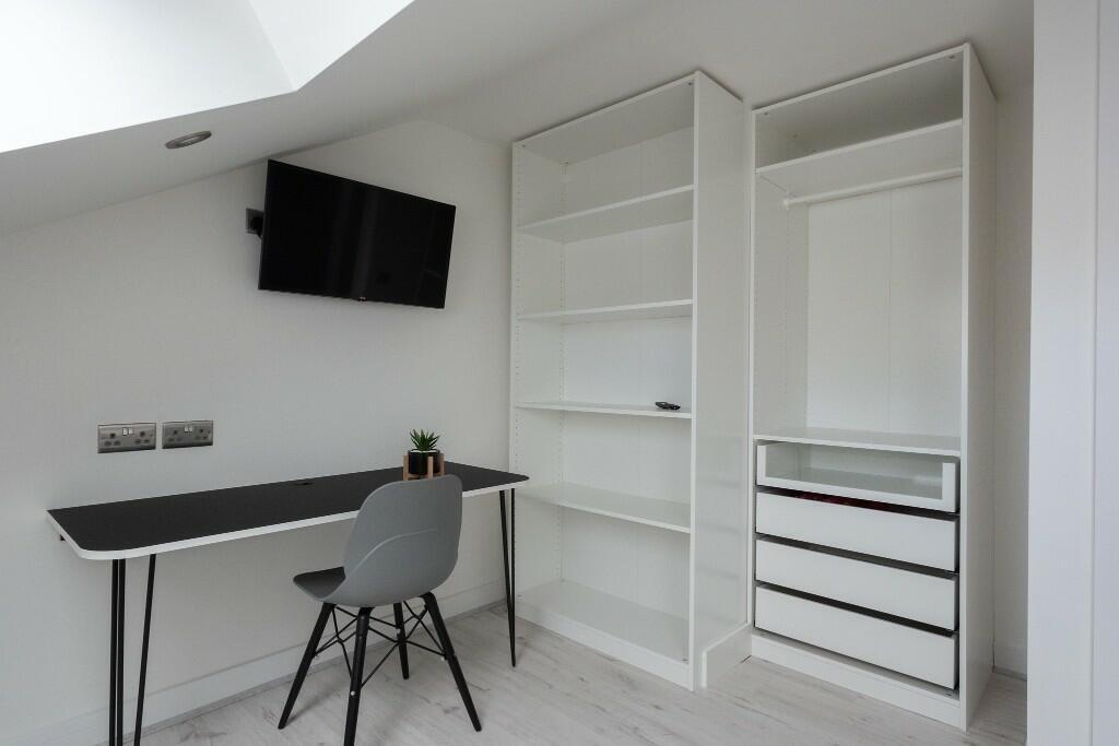 Bright, modern bedroom corner with built-in ope...