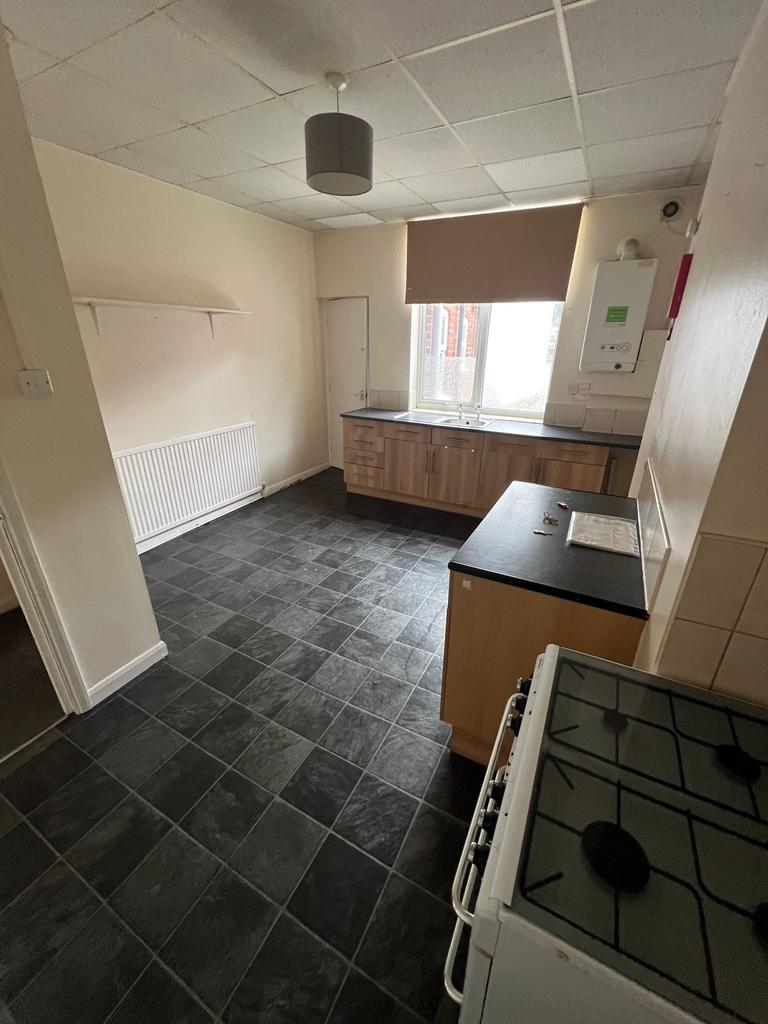 A functional kitchen space with ample black til...