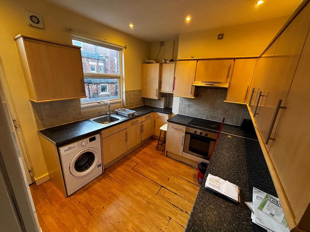 Bright galley kitchen with plenty of fitted sto...