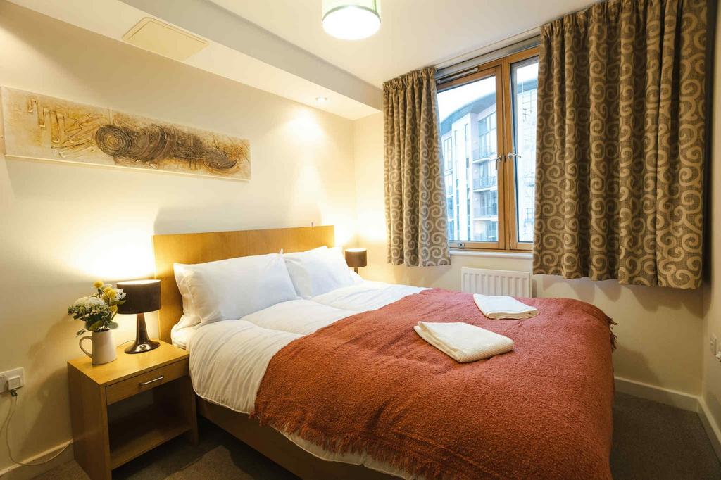 A cozy double bedroom featuring a comfortable d...