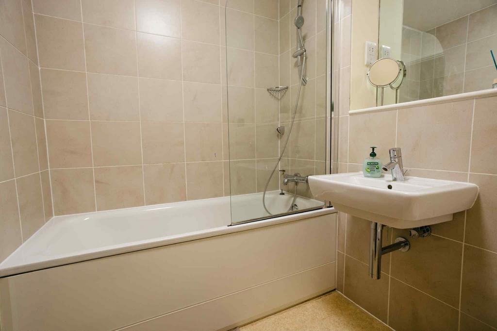 A modern bathroom suite featuring a clean white...