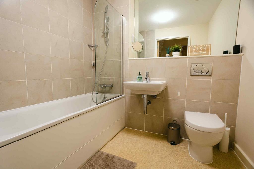 Modern bathroom suite featuring a clean bathtub...