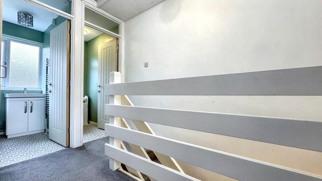 A bright and tidy hallway featuring a modern wh...