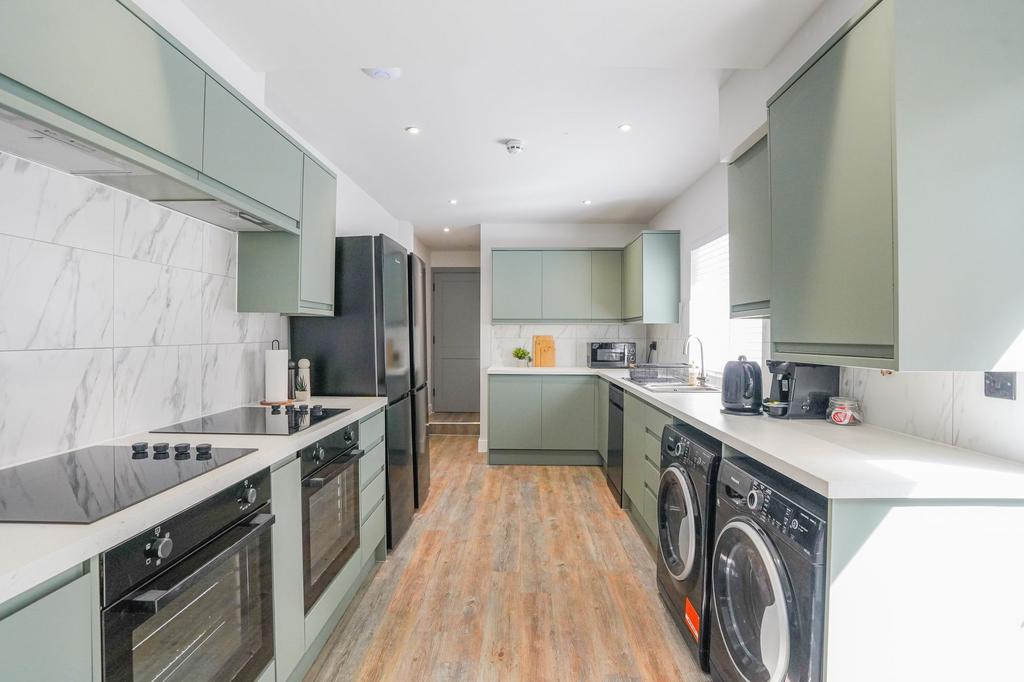 Bright and modern kitchen with sleek cabinetry ...