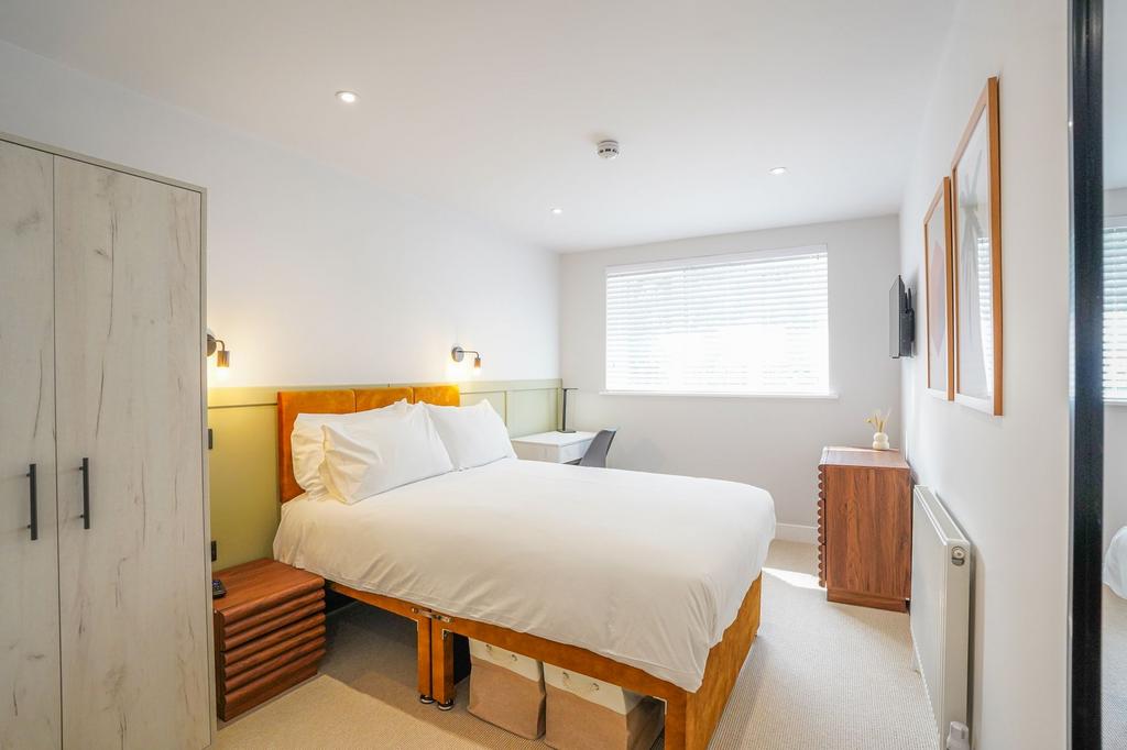 Bright and inviting master bedroom featuring a ...