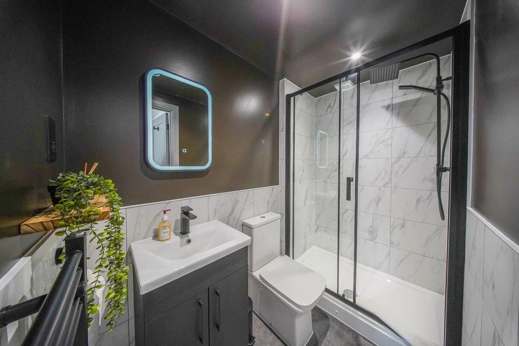 Modern bathroom featuring a sleek vanity with a...