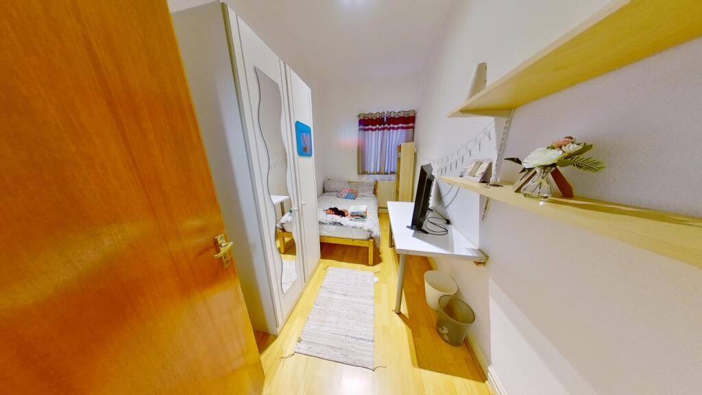 Bright and tidy single toilet room featuring cl...