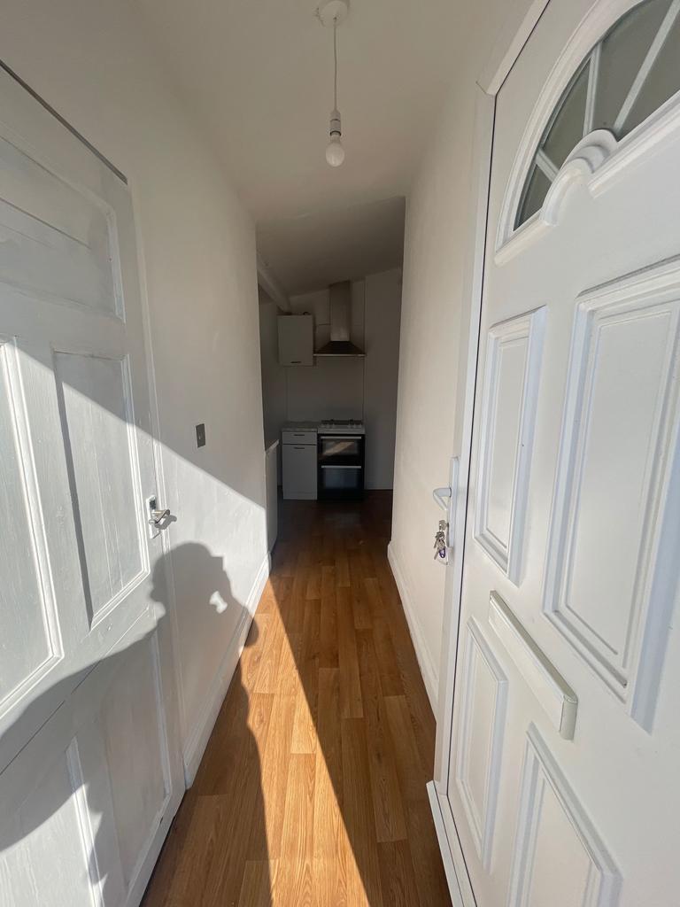 A bright and clean hallway featuring warm woode...