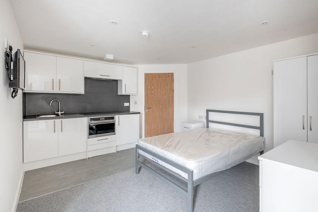 Bright and modern double bedroom featuring a sl...