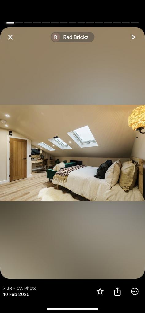 A stylish, spacious attic master bedroom featur...