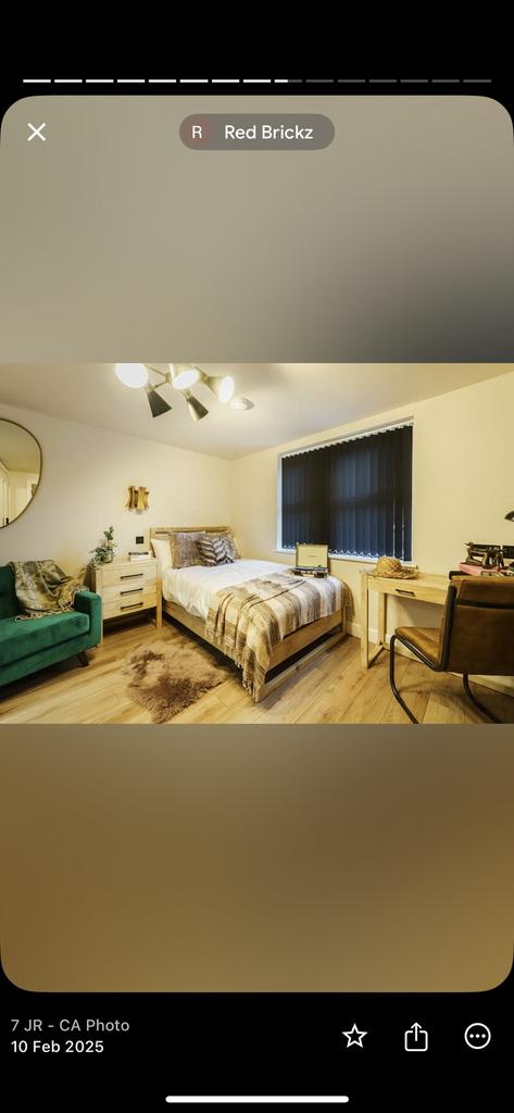 A cozy, well-furnished bedroom featuring a sing...