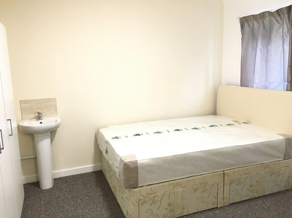 A neat and well-maintained bedroom featuring a ...