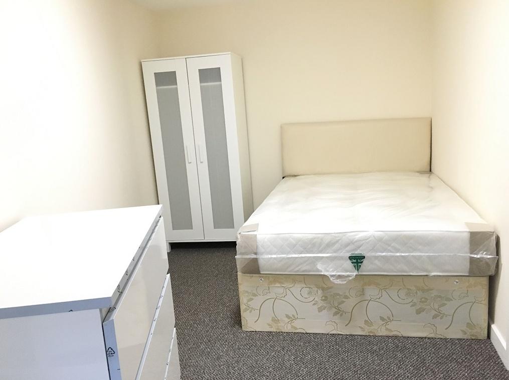 A neat and bright single bedroom featuring a co...