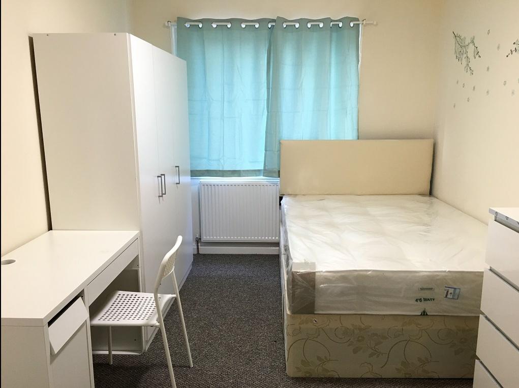 Bright and tidy double bedroom featuring a clea...