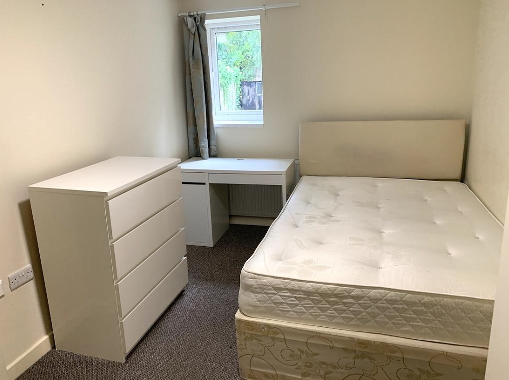 A clean and simple double bedroom featuring a c...