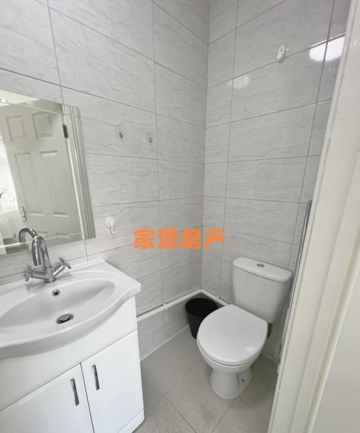 A clean and modern small bathroom featuring a w...