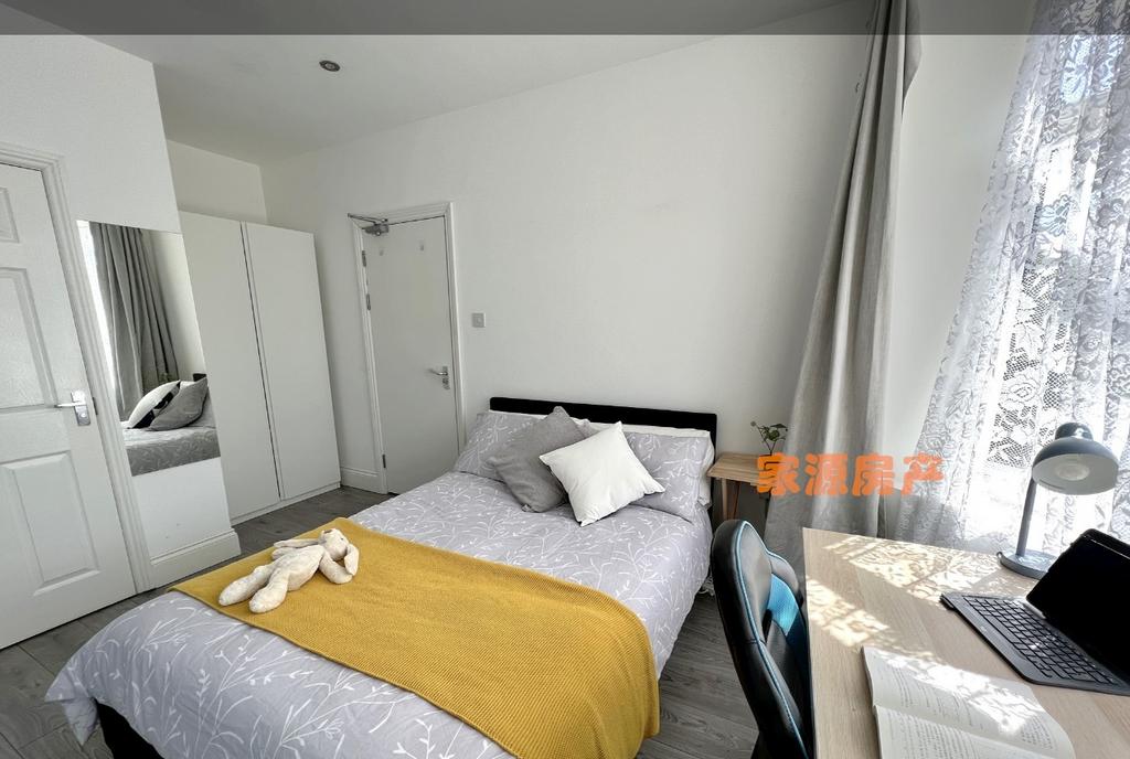Bright and cozy double bedroom featuring a comf...