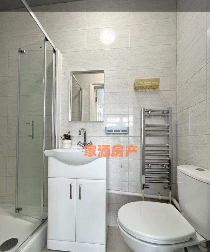 Bright and modern bathroom suite featuring a cl...