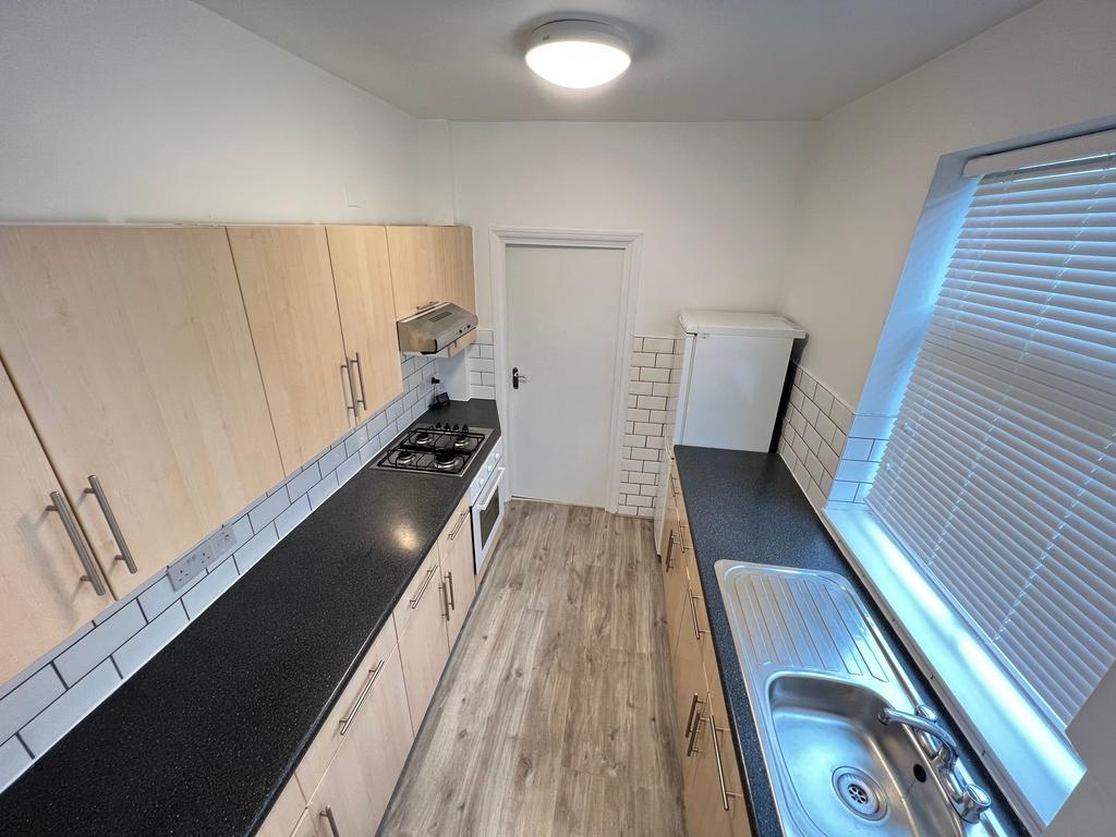 Bright and clean kitchen featuring modern light...
