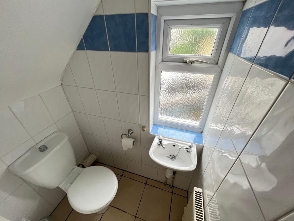 Compact and tidy toilet room featuring a clean ...