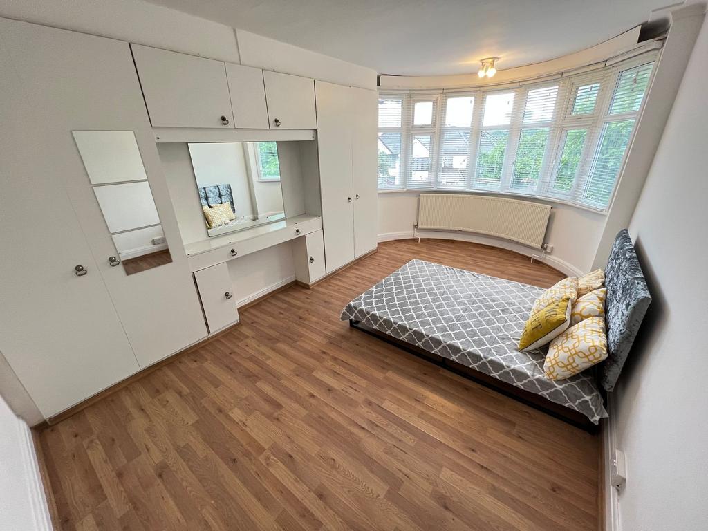 Bright and spacious master bedroom featuring a ...