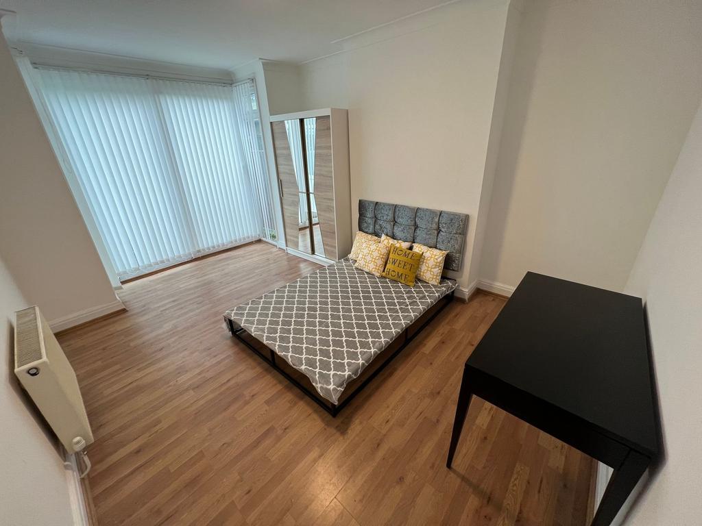 A neat and bright double bedroom featuring a co...