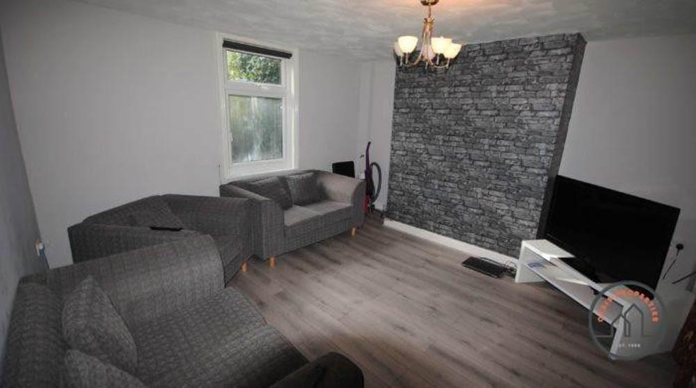A cozy living room featuring modern grey sofas,...