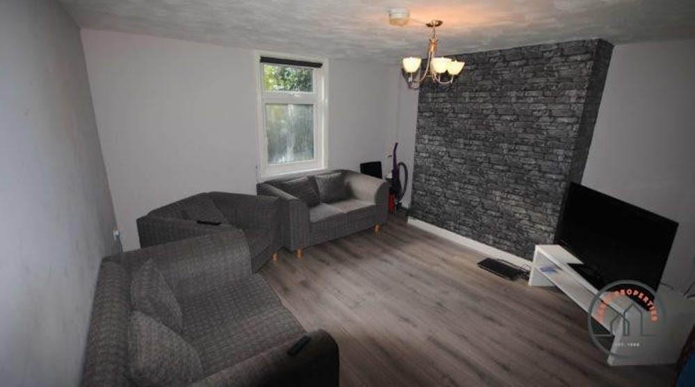 A cozy living room featuring modern grey sofas,...