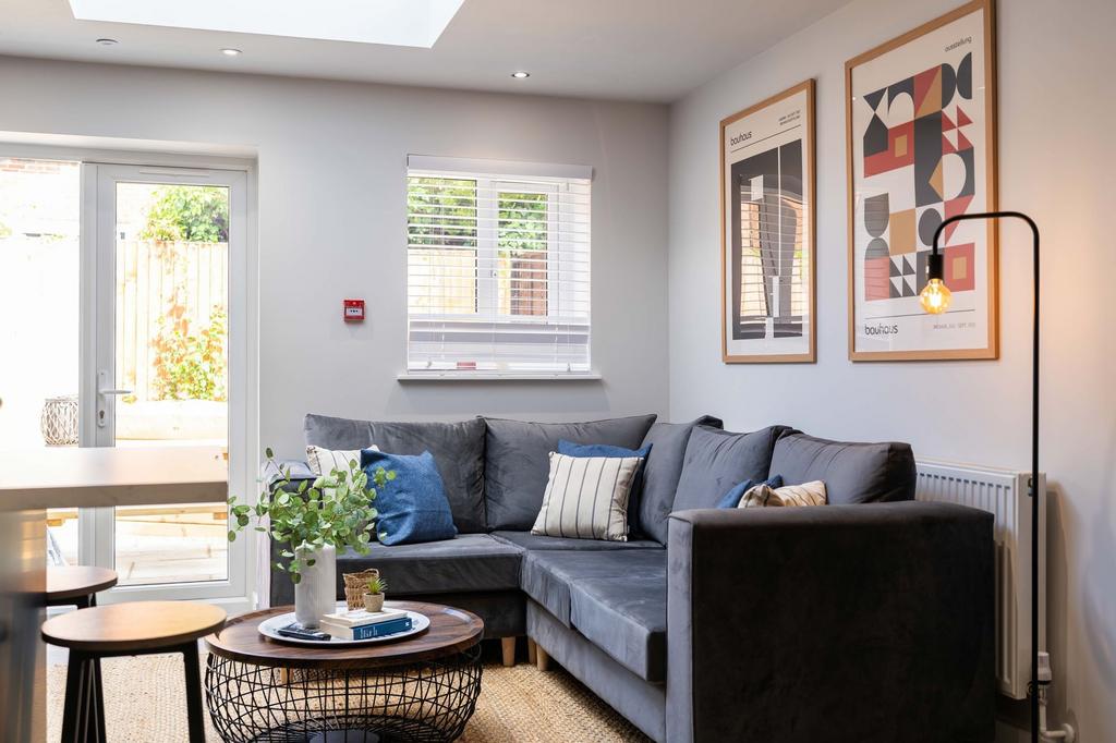 Bright and stylish living room featuring a comf...