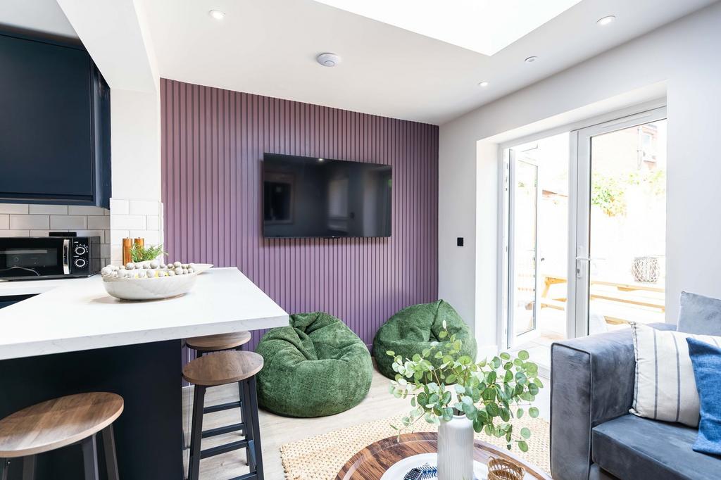 Bright and modern living room featuring a large...