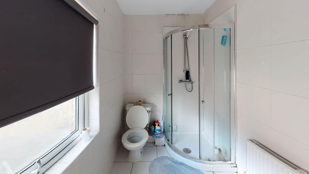 A clean and modern bathroom featuring a curved ...