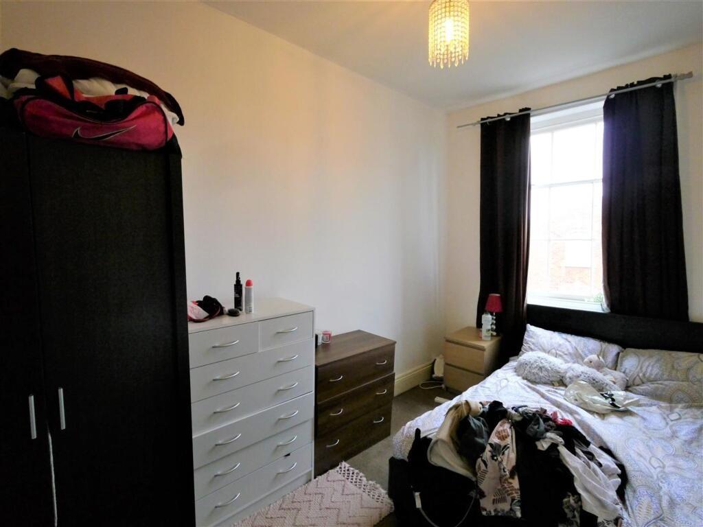 A cozy bedroom featuring a double bed, a wardro...