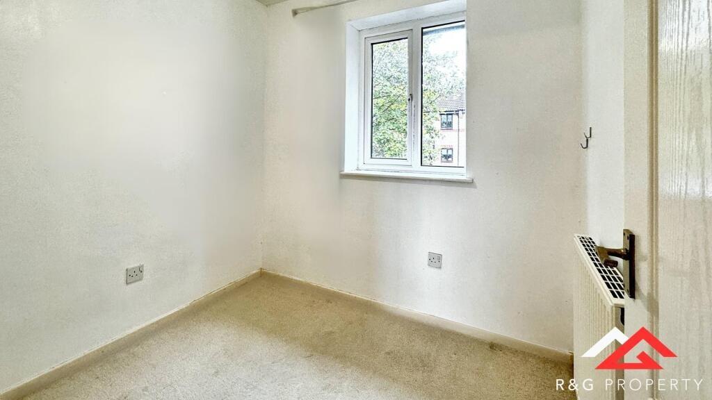 A bright, clean single bedroom with a large win...