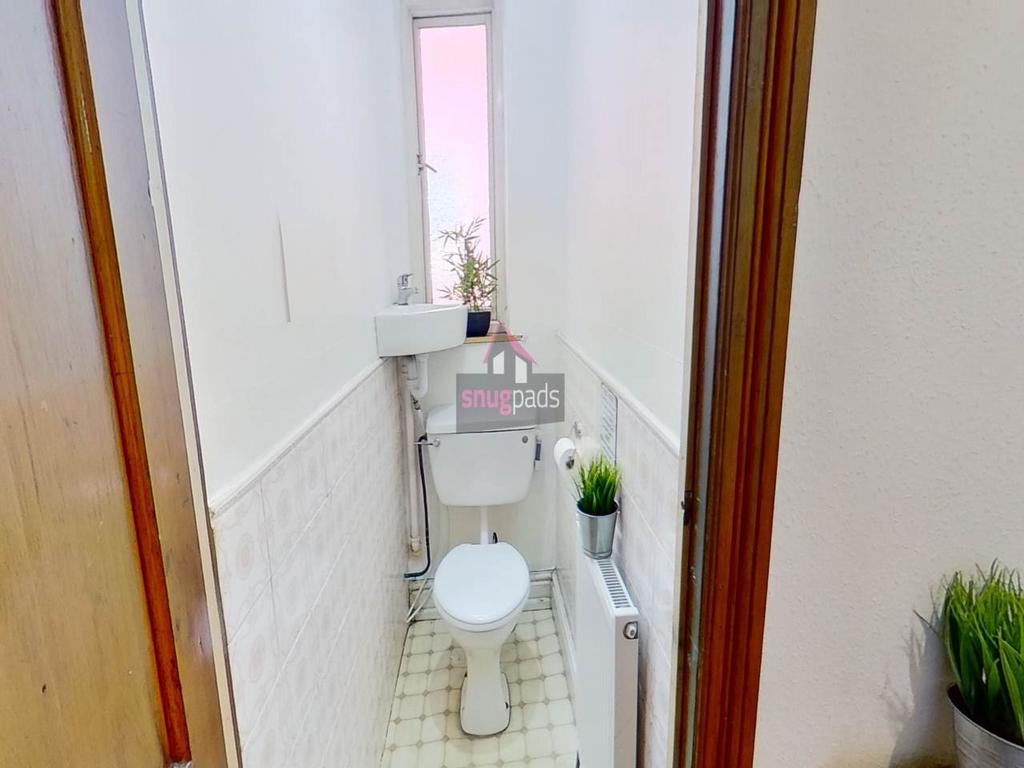 A neat and bright single toilet with a small si...