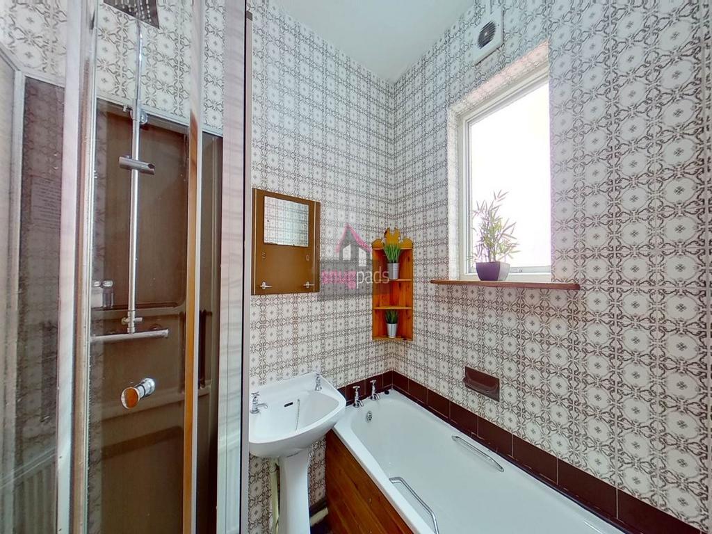 A bright and tidy bathroom featuring a spacious...