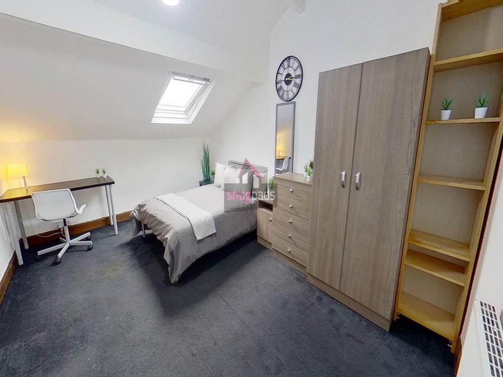 Bright and cozy bedroom featuring a single bed,...