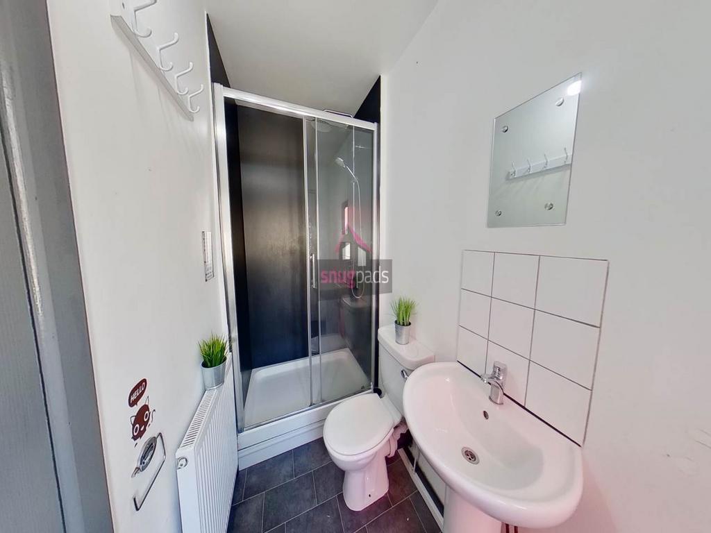 A clean, modern bathroom featuring a shower cub...