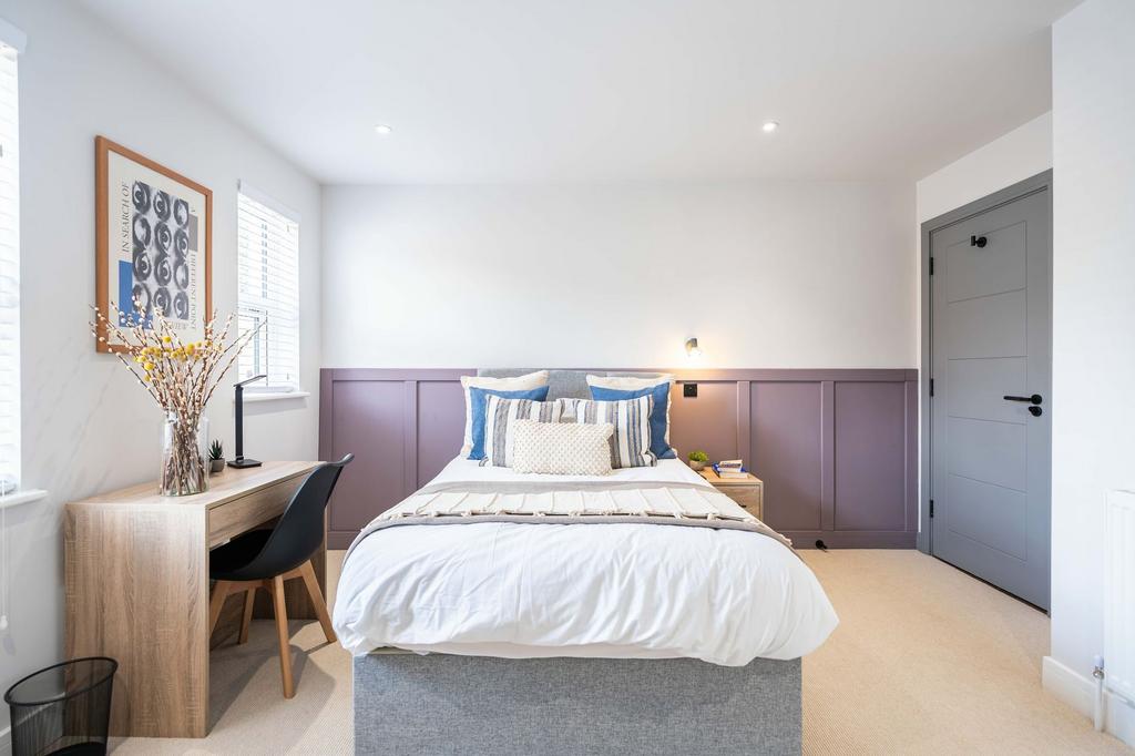 Bright and modern bedroom featuring a comfortab...