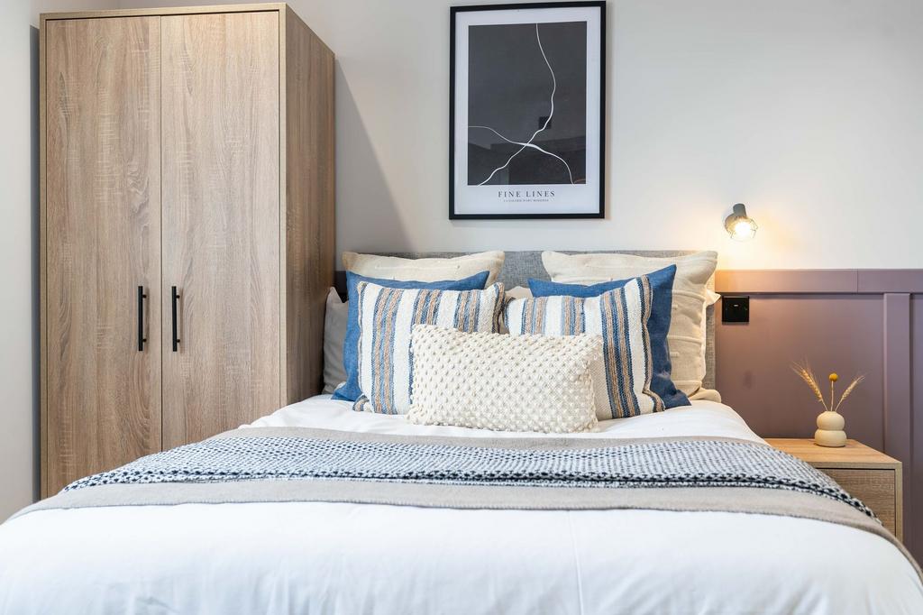 A spacious, well-maintained master bedroom feat...